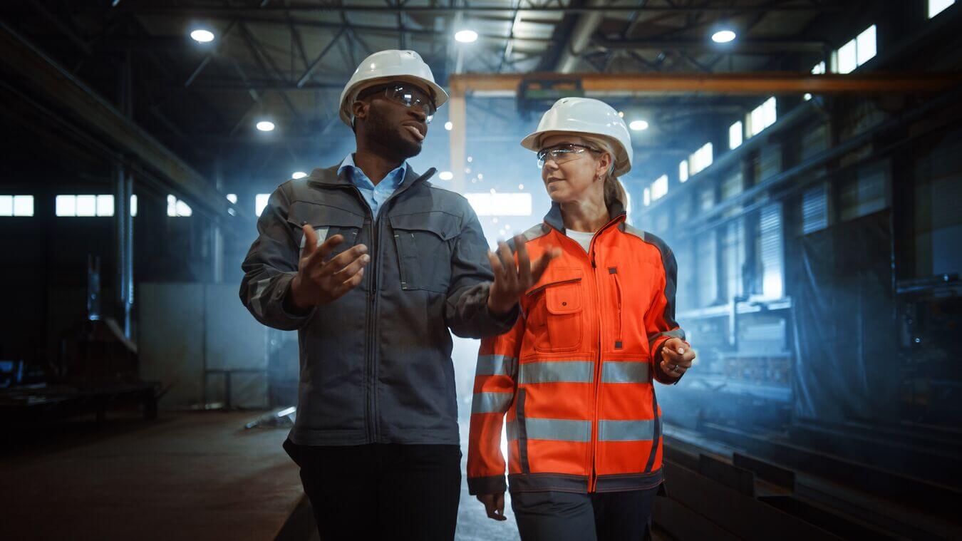 Stock photo of two employees in a manufacturing facility.
