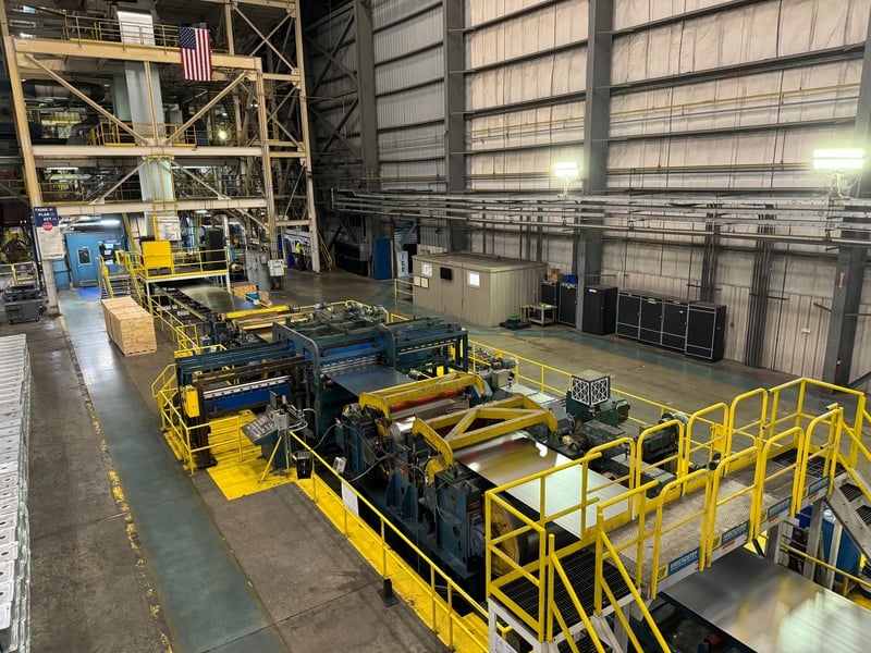 A zoomed out look of a galvanized steel coil finishing processing from the cooling tower to the exit end.