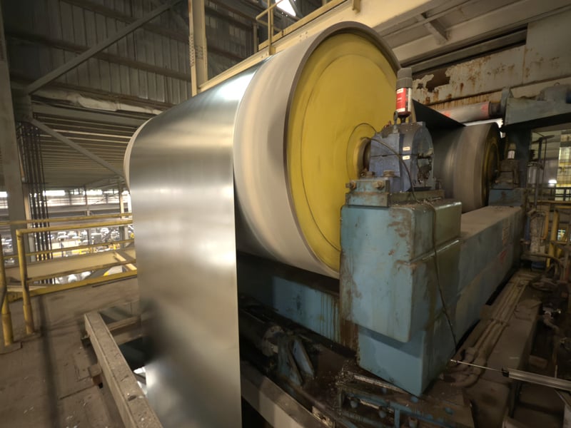 A coil going through the hot dipped galvanization line, going over a roller for further processing.