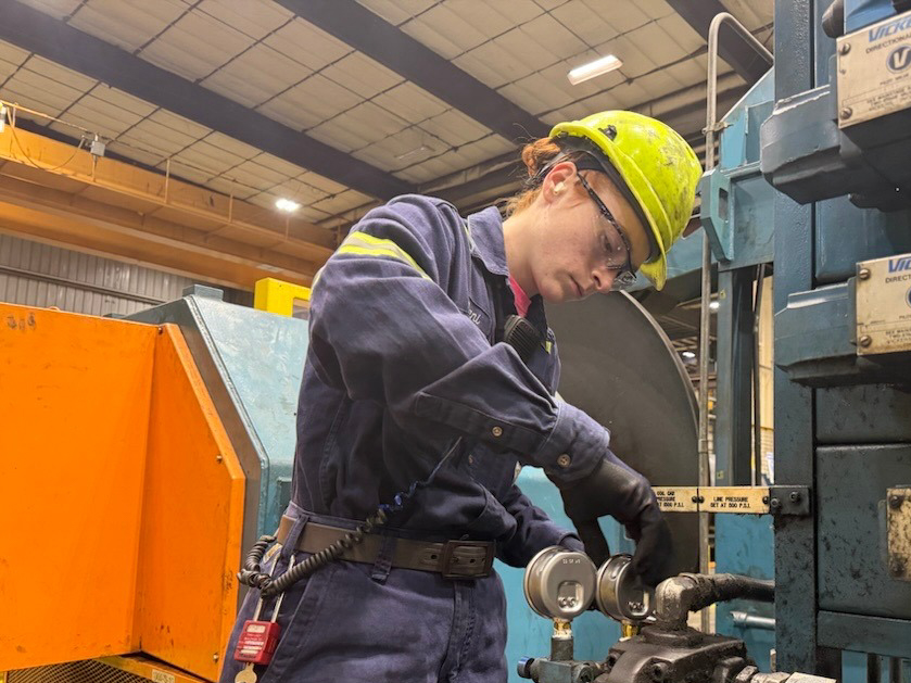 A Worthington Steel employee working on a machine.