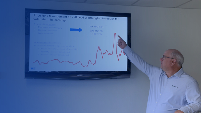 A Worthington Steel employee demonstrating with digital graphs the importance of price risk management with your steel buy.