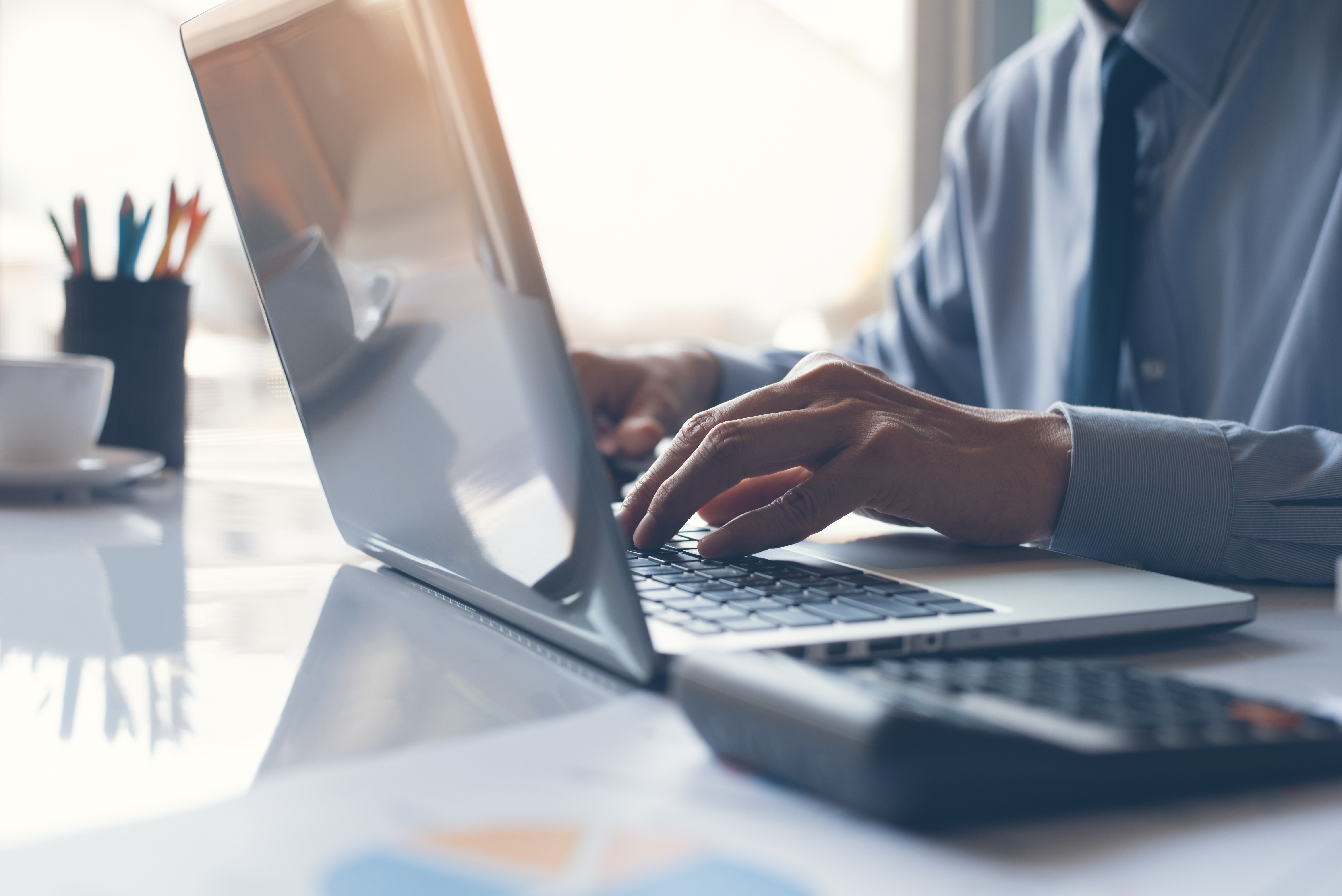 Stock image of a person typing on a computer.