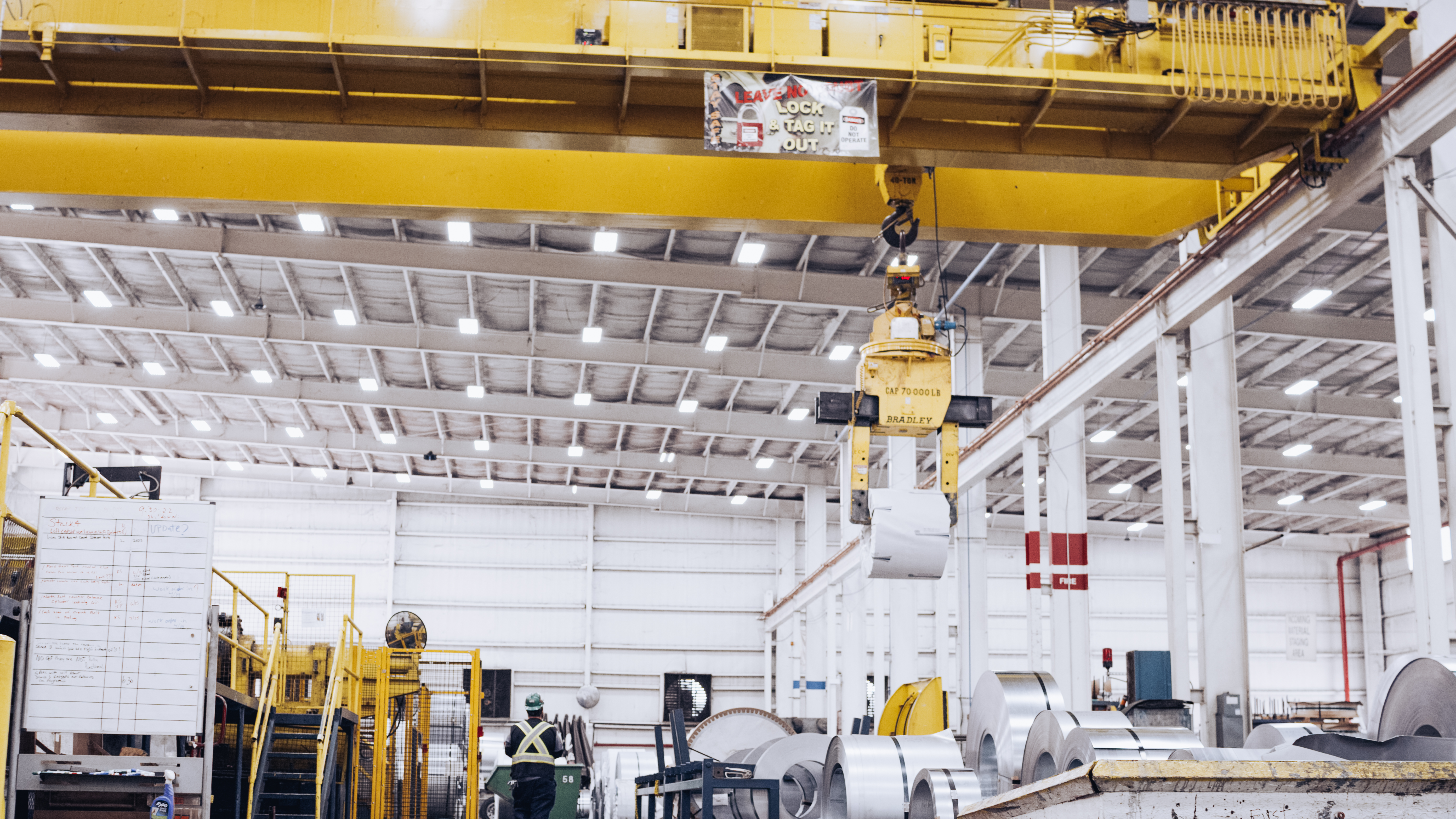 A steel coil being carried by an overhead crane at a Worthington Steel facility.