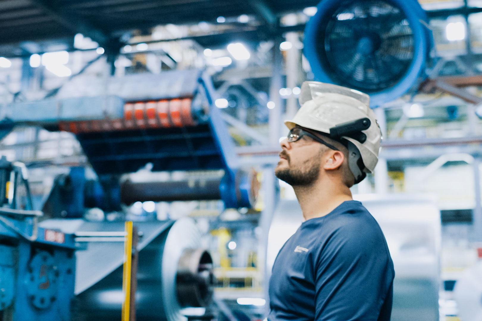 Worthington Steel steel processing facility employee looking up at machinery